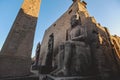 Sunset View to the Illuminated Stone Statues of the large Ancient Egyptian temple in Luxor Royalty Free Stock Photo