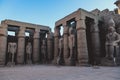 Sunset View to the Illuminated Stone Statues of the large Ancient Egyptian temple in Luxor Royalty Free Stock Photo