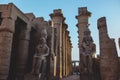 Sunset View to the Illuminated Stone Statues of the large Ancient Egyptian temple in Luxor Royalty Free Stock Photo