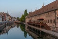 Sunset view of waterfront of a channel passing ancienne douanne building in Strasbourg, France