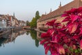 Sunset view of waterfront of a channel passing ancienne douanne building in Strasbourg, France