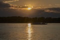 Sunset on the Volga River. In the distance there are mountains Zhiguli. The golden path is reflected in the water. Royalty Free Stock Photo