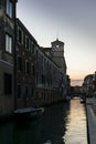 The sunset on a water channel in Venice during summer