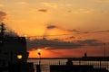 Sunset on the waterfront with the lampposts of the harbor in backlight Royalty Free Stock Photo