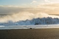 Sunset in the waves at beautiful beach with black volcanic sand, Iceland Royalty Free Stock Photo