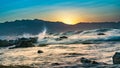 sunset, waves breaking on rocks Royalty Free Stock Photo