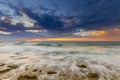 Sunset and the waves lapping on the rocky shore