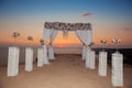 Sunset. Wedding ceremony arch with flowers decorative arrangement with white curtain on cliff above sea, sunrise outdoor summer p Royalty Free Stock Photo