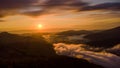 Sunset and white mist or cloud scenic aerial view. Flying through the clouds and fog above mountain tops. Royalty Free Stock Photo