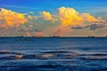 Before sunset, the whole sky is full of charming golden clouds and various ships waiting to enter the port in the wide sea