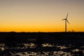 Sunset with wind turbine and flying birds Royalty Free Stock Photo