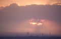 Sunset with wind turbines in a distant landscape Royalty Free Stock Photo