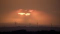 Sunset with wind turbines in a distant landscape Royalty Free Stock Photo