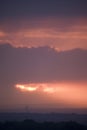 Sunset with wind turbines in a distant landscape