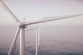 Sunset wind turbines in sea, ocean. Clean energy, wind energy, ecological concept. 3d rendering Royalty Free Stock Photo