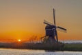 Sunset with windmill Broekmolen, Molenlanden - Nieuwpoort, The Netherlands Royalty Free Stock Photo