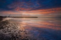 Sunset, windmill, stones and surf