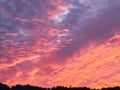 sunset in a winter day. Sunshine over the hill and houses. Silhouettes Royalty Free Stock Photo