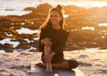 Sunset, woman with yoga mat and at beach happy with a lens flare. Fitness or exercise, meditation or freedom and female Royalty Free Stock Photo