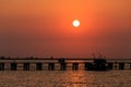 Sunset at wooden pier and ship Royalty Free Stock Photo