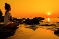 sunset yoga woman with spirituality on sea coast