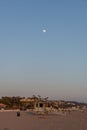 Sunset at the Zuma Beach in Malibu, California, with the full moon above the lifeguard station Royalty Free Stock Photo