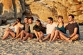 Sunsets are better when you share them. a group of happy young friends admiring the sunset together while sitting on the Royalty Free Stock Photo