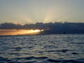 Sunsets through the clouds over Waianae mountains Royalty Free Stock Photo