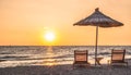 Sunshade beach umbrellas with sunset sky and sea background. Sarande, Albania