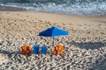 Sunshade and chairs on the beach in the strong sun of the day