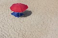 Sunshade and towel on empty beach
