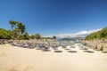 Sunshade umbrellas and deckchairs on the small beautiful Ksamil beach, Albania.