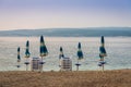 Sunshades and deck chairs on the empty beach of Crikvenica