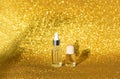 Sunshin glitter background. Skincare oil concept. Glass bottle