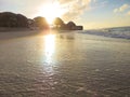 Sunshine on the beach reflections on wet sand Royalty Free Stock Photo