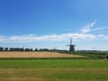 Sunshine over countryside road and windmill, Holland Royalty Free Stock Photo