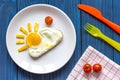 Sunshine fried eggs breakfast for kid on blue background Royalty Free Stock Photo