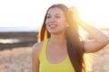 Sunshine girl at sunset. Beautiful smiling young woman enjoy life walking on empty beach at sunset Royalty Free Stock Photo