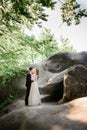 Sunshine illuminates beautiful hugging wedding couple