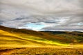 Sunshine lighting up the mountain grassland Royalty Free Stock Photo