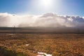 Sunshine over low clouds above vast and empty land along Volcanic Loop Hwy and Desert Road. Central Plateau, New Zealand