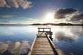 Sunshine over wooden pier on big lake Royalty Free Stock Photo