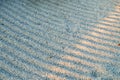 Sunshine ray on surface of gravel grooves symbolic rows in Gravel Stones Garden. Royalty Free Stock Photo