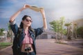 Sunshine in the summer and women traveler hold a map to protect