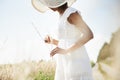 Sunshine, wheat field and woman with nature, grass and environment with break, weekend and landscape. Person, girl and