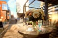 sunshine white roses cup of coffee and blue glass of wine on wooden table at street cafe plant shadow sunlight reflection on