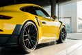 Sunshine on yellow luxury porshe in car showroom