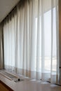 sunshire light looking pass Translucent white fabric curtains an Royalty Free Stock Photo