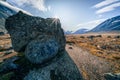 Sunstar on the edge of a big boulder sitting on the floor of remote arctic valley. Akshayuk Pass, Baffin Island, Canada