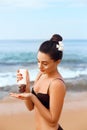 Suntan Lotion. Sexy Young Woman Applying Sunscreen Solar Cream on the beach.Sun Protection. Royalty Free Stock Photo